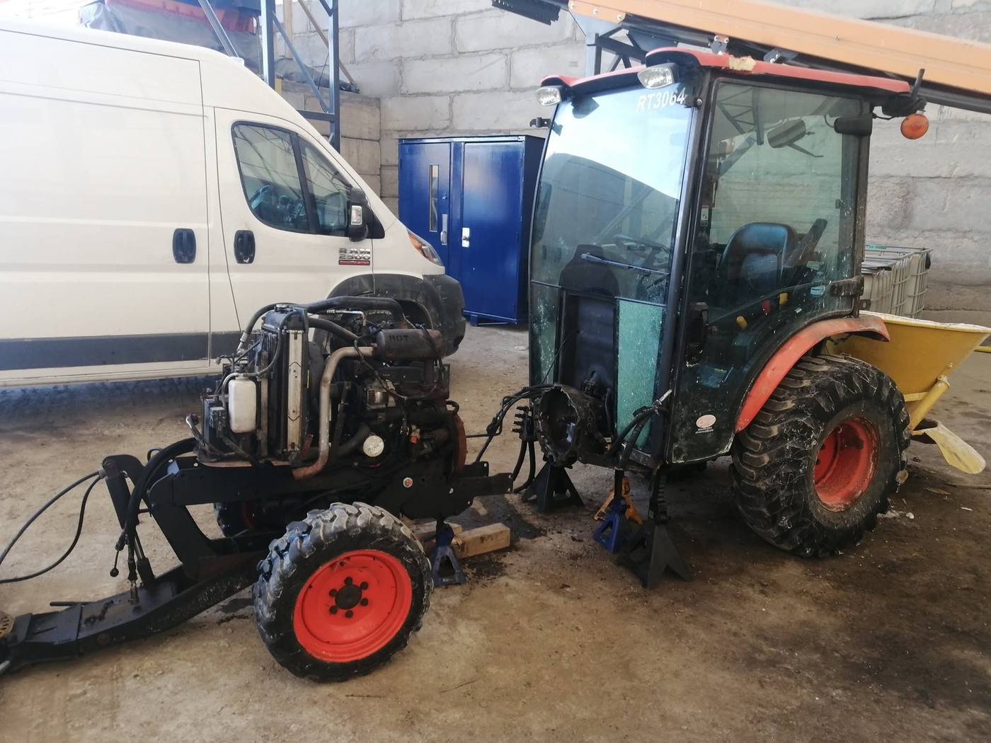 Compact tractor split in half on jack stands for clutch and transmission repair