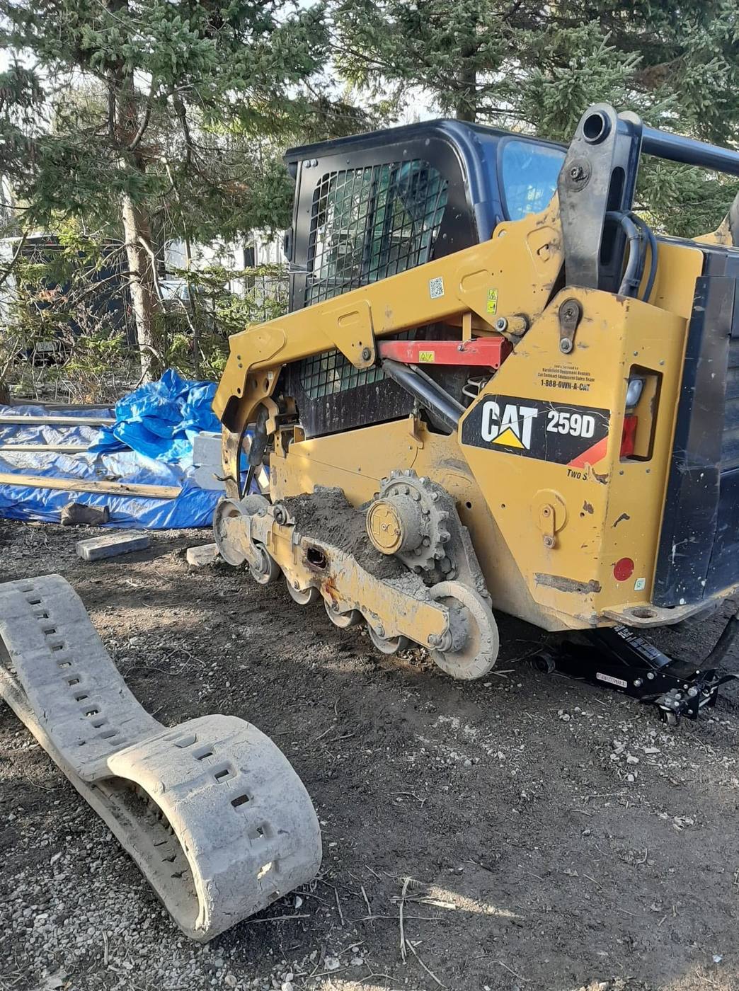 CAT 259D compact track loader with rubber track removed for undercarriage service